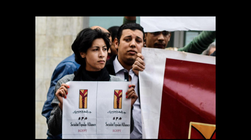 Image of El Sabbagh holding a poster